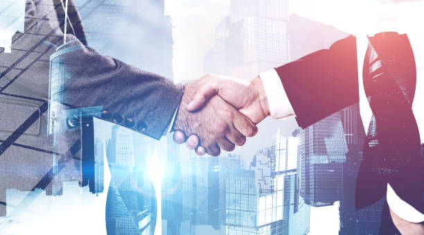 istock Two businessmen shaking hands in city 1202249885
