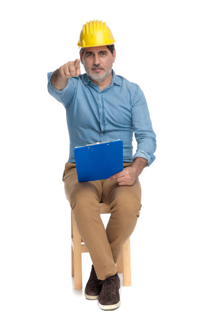 istock Confident casual man holding a clipboard and pointing forward 1202250506