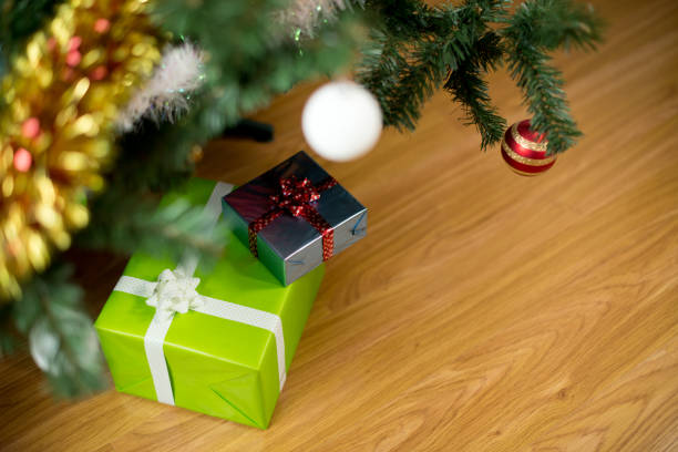 istock Two gifts of different sizes lie under the Christmas tree 1202250969