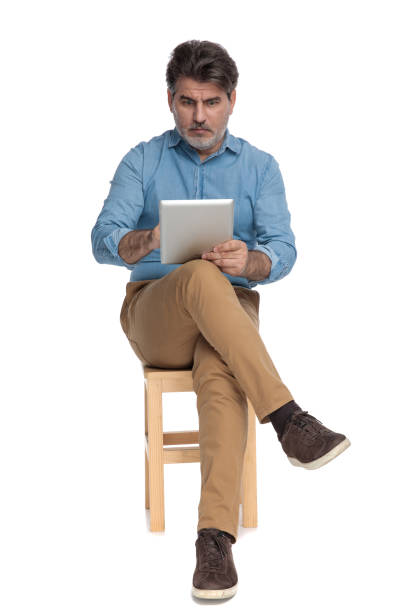 istock Shocked casual man reading and writing on his tablet 1202251194