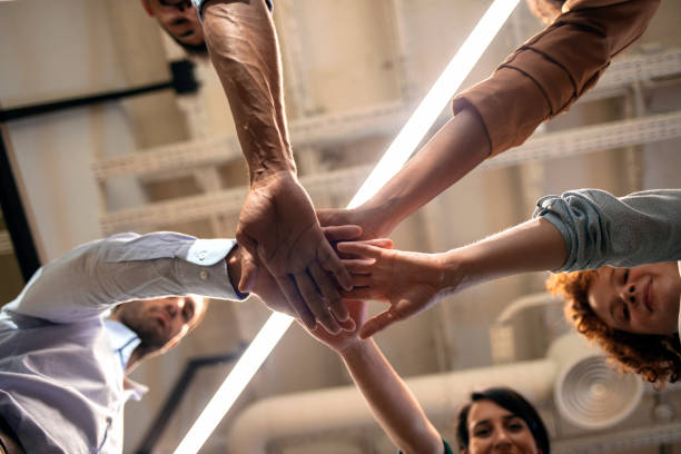 istock Happy business team giving high five in office 1202253476
