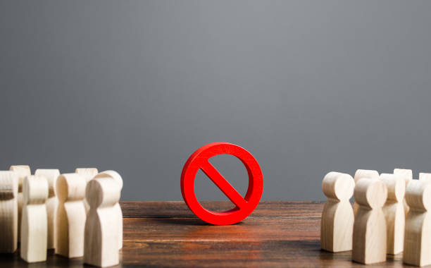 istock People looking at red prohibition sign NO. prohibition, taboo, and rejection. Conservatism, misunderstanding new. Laws Restrictions of rights and freedoms. Civil conflict. Fear and prejudice 1202254832