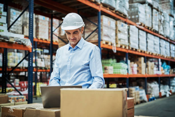 istock Confident male manger working on laptop at factory 1202254833