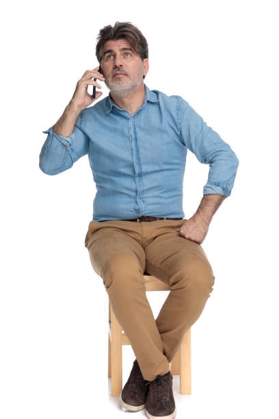 istock Pensive casual man talking on his phone and looking away 1202256167