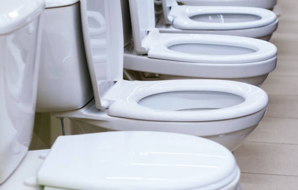 istock white toilets close-up selective focus. 1202256386