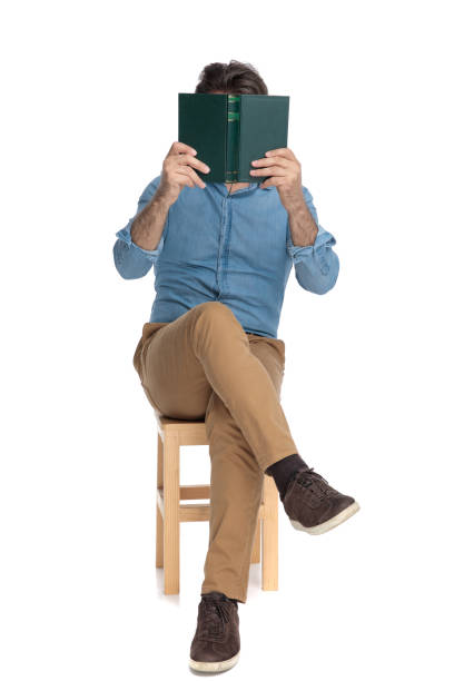 istock Old casual man covering his face with a book 1202257195