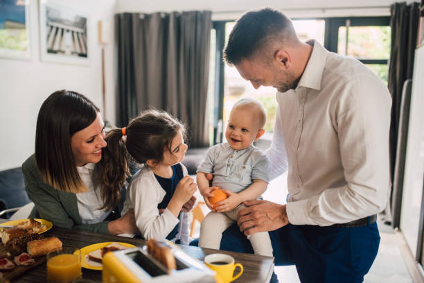 istock Happy family with two children having a breakfast 1202257412