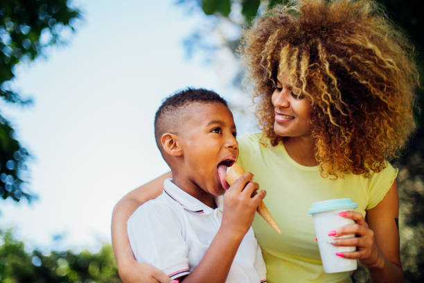 istock Boy enjoying ice cream and spending time with his mom 1202257581