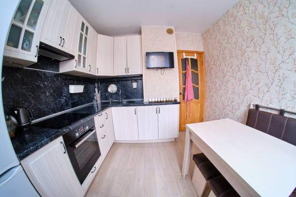 istock Modern black and white kitchen. High gloss kitchen with table and countertop (fisheye photo) 1202259275
