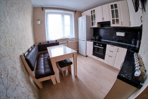 Contemporary black and white kitchen with functional cupboards and modern equipment (fisheye photo)