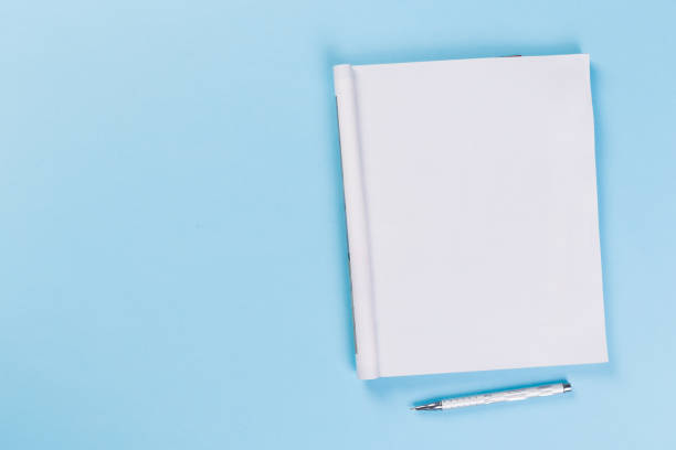istock Sketchbook on colorful background. Copy space. top view of blank open notebook, concept of education or new workplace 1202259390