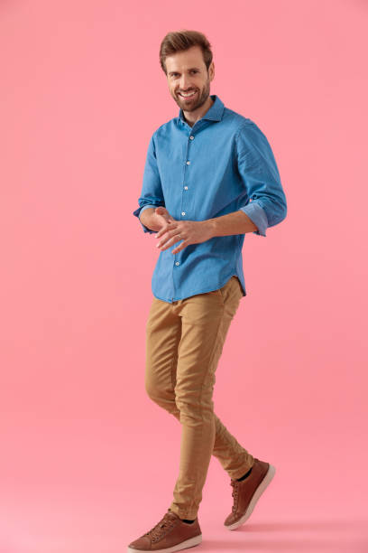 istock happy young guy in denim shirt laughing and rubbing palms 1202260785