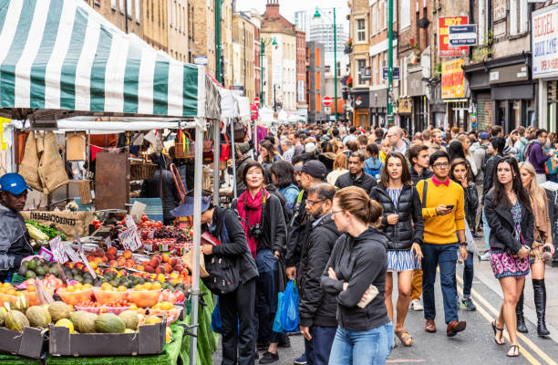 London, UK - Market stalls along Brick Lane in East London busy with visitors.