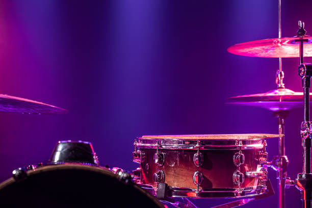 istock Drums and drum set. Beautiful blue and red background, with rays of light. Beautiful special effects of smoke and lighting. Musical instrument. Close-up photo. 1202260977