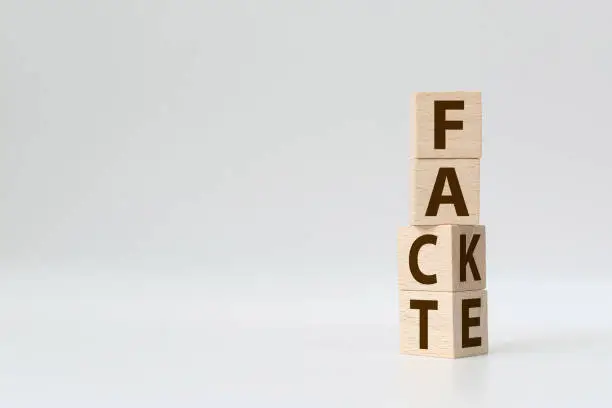 Photo of Fact or Fake concept, Wooden cube change the word, April fools day