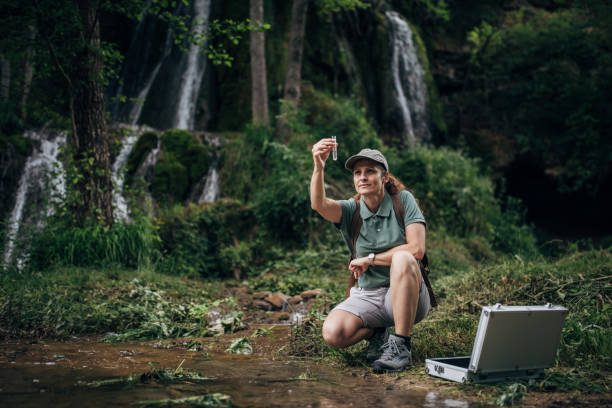istock Female biologist taking water sample for research 1202263426