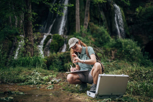 istock One female biologist taking water sample for research 1202263515