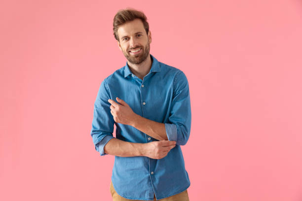 istock happy casual man smiling and arranging shirt 1202263593
