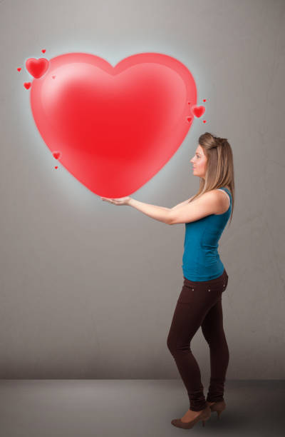 istock Young lady holding lovely 3d red heart 1202263696