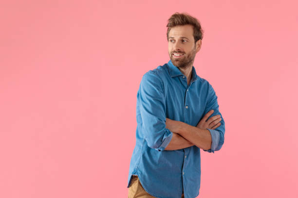 istock happy casual man looking to side and crossing arms 1202263736