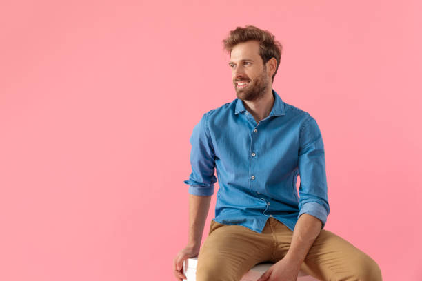 istock happy young casual man looking to side and smiling 1202264763
