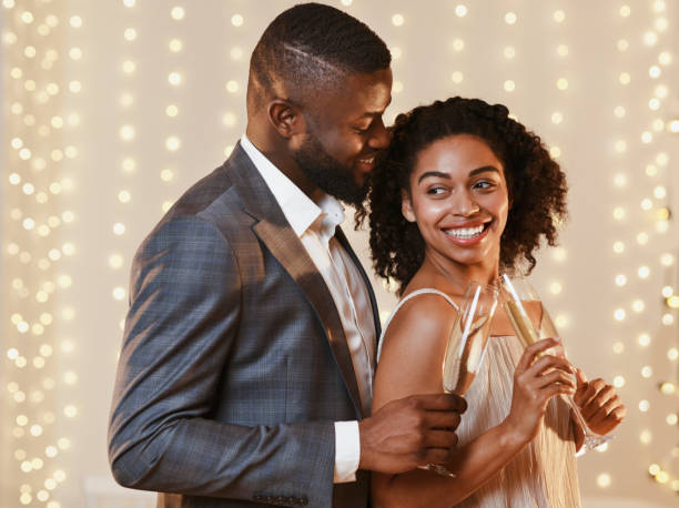 istock Black couple in love drinking champagne, having date 1202265247