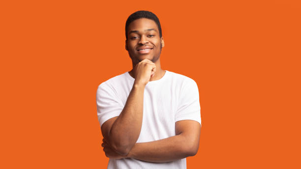istock Pensive afro man portrait on orange background 1202266388