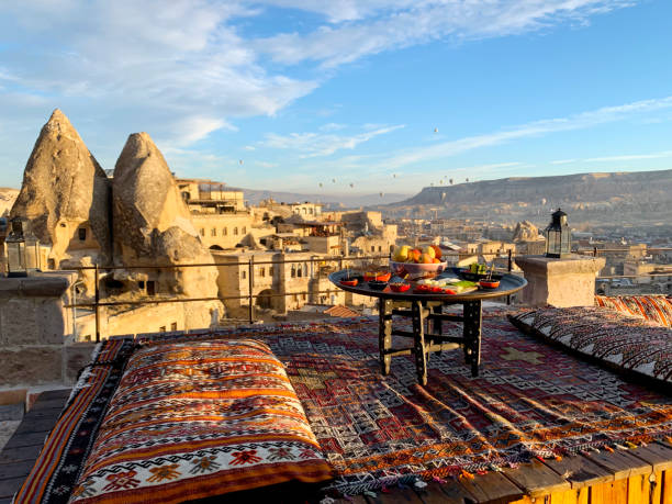 travel in cappadocia colorful hot air balloons flying over the valley sunrise time with special breakfast travel destination in turkey - cappadocia hot air balloon turkey basket imagens e fotografias de stock