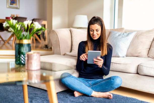 istock Attractive woman with digital tablet relaxing at home 1202266766