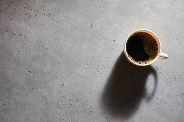 istock Cup of coffee on a gray background top view. Copyspace 1202268509
