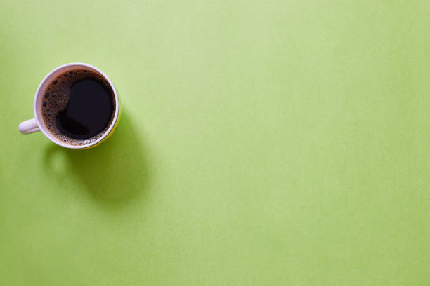 istock Coffee espresso in cup on pastel colored minimal background. Copy space, top view. Morning black coffee 1202269089