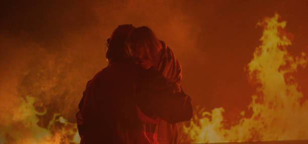 istock Firefighter saves a girl from the fire 1202269258