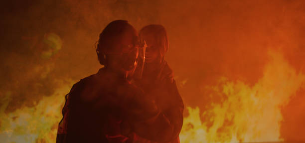 istock Firefighter saves a girl from the fire 1202269312