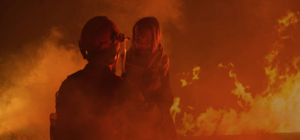 istock Firefighter saves a girl from the fire 1202269439