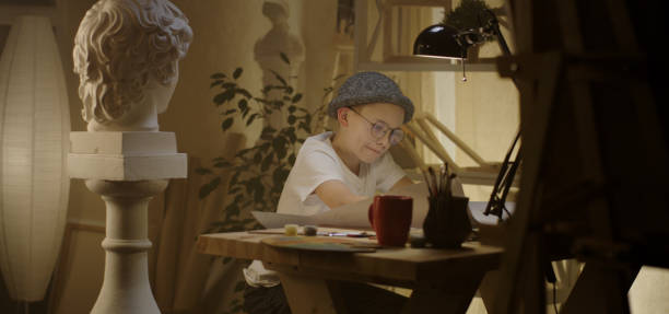 istock Young artist drawing at table 1202269445