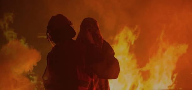 istock Firefighter saves a girl from the fire 1202269470