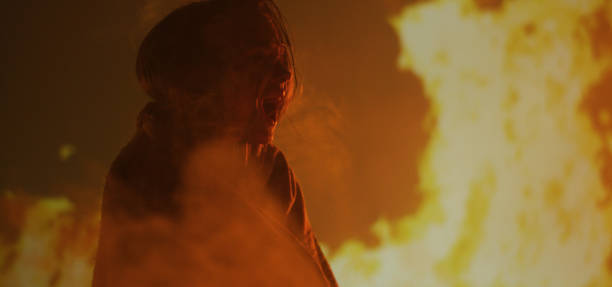 istock Girl trapped in fire crying for help 1202269478
