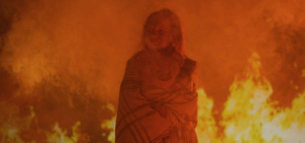 istock Girl trapped in fire crying 1202269524