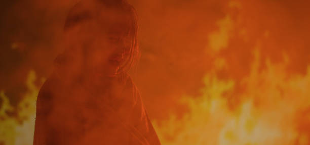istock Girl trapped in fire crying for help 1202269531