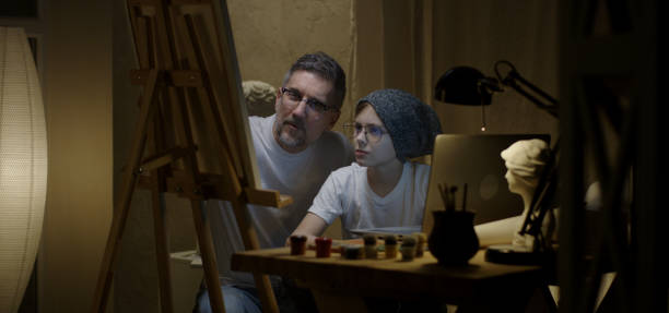istock Artist and son painting together 1202269574