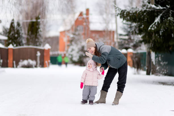 istock A young mother points at something to her little daughter 1202269593