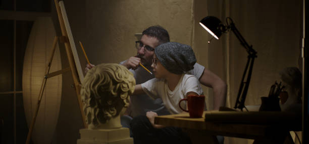 istock Father and son studying sculpture 1202269628