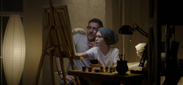 istock Father and son painting together 1202269641