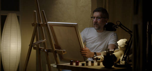 istock Artist sits down to his desk 1202269694