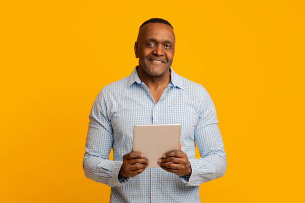 istock Friendly mature african businessman holding digital tablet 1202271508