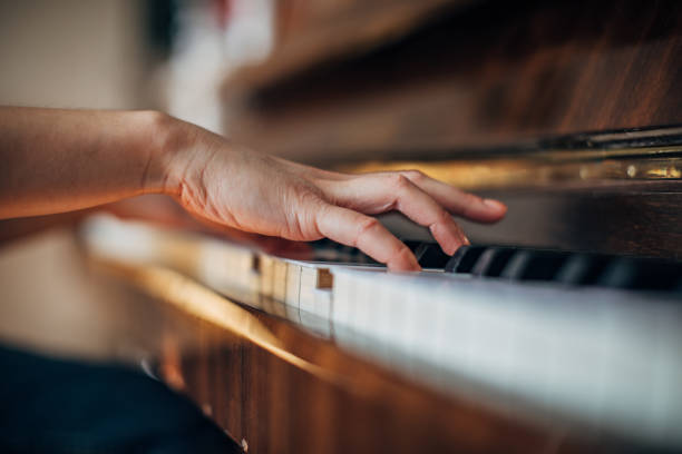 istock Woman pianist playing piano 1202271602