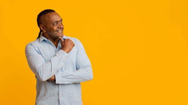 istock Cheerful pensive mature african man looking at empty space 1202272215