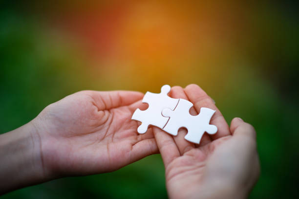 istock Hands and puzzles, important pieces of teamwork Teamwork concept 1202273016