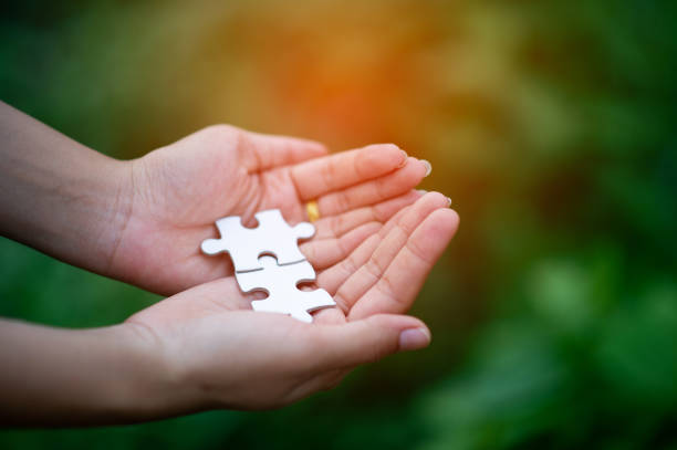istock Hands and puzzles, important pieces of teamwork Teamwork concept 1202273155