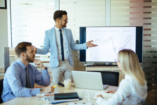 istock Young male executive leading presentation in meeting room 1202273374